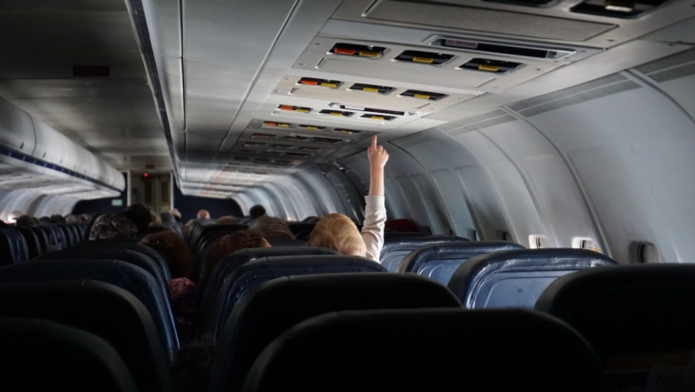 woman raising her hand on passenger seat