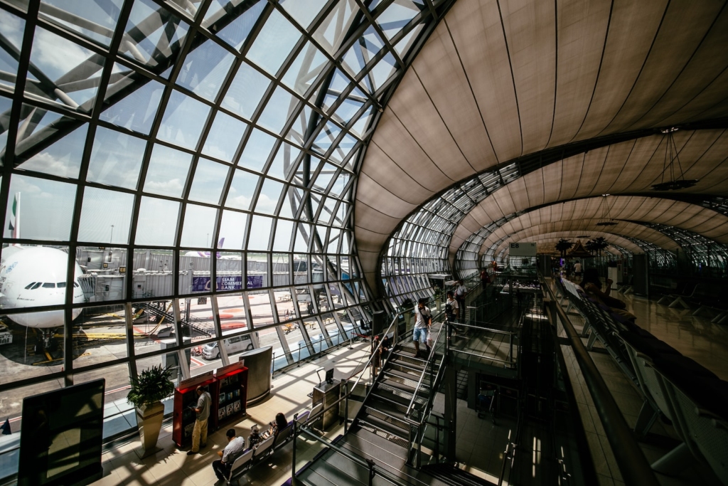people walking and sitting inside the airport