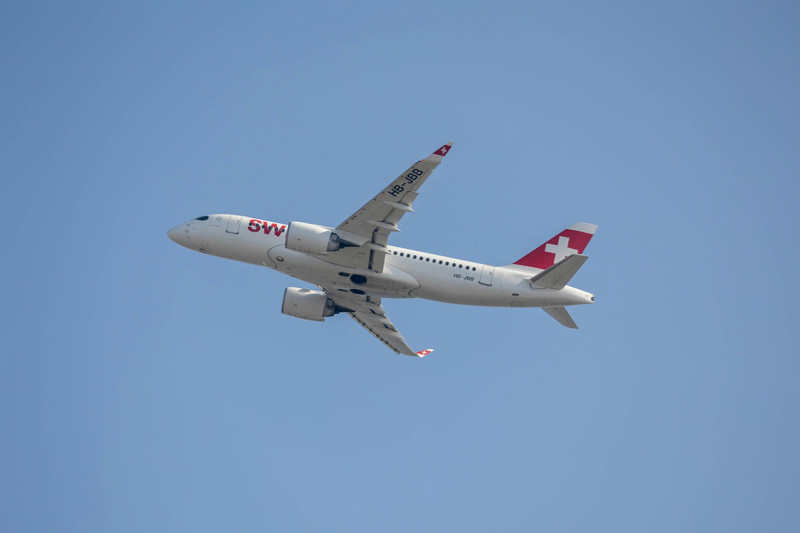 a large passenger jet flying through a blue sky