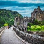man and woman talking on gray concrete bridge