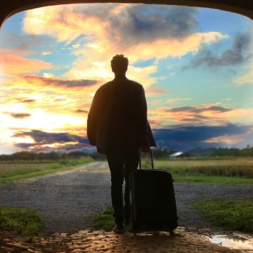 man holding luggage photo