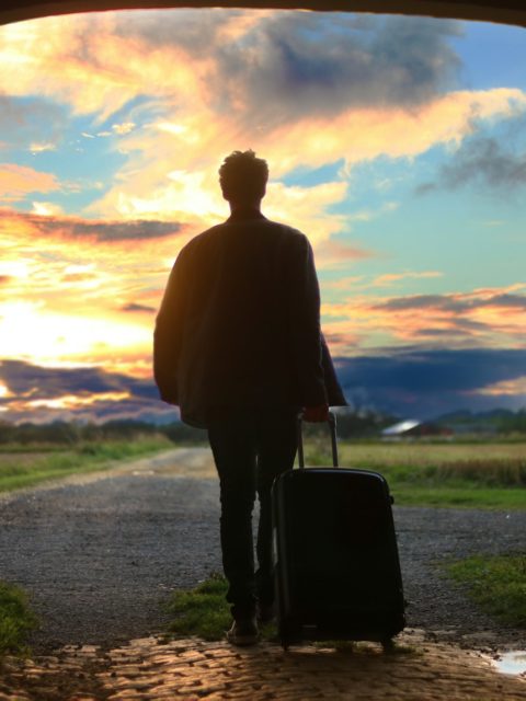 man holding luggage photo