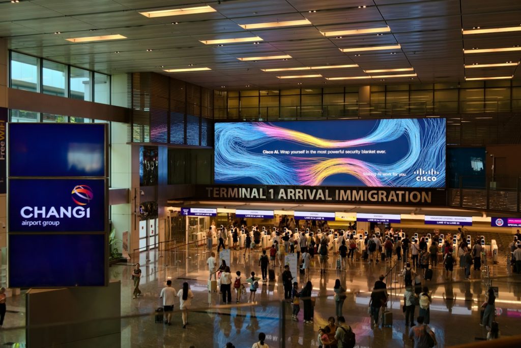 A group of people walking through an airport