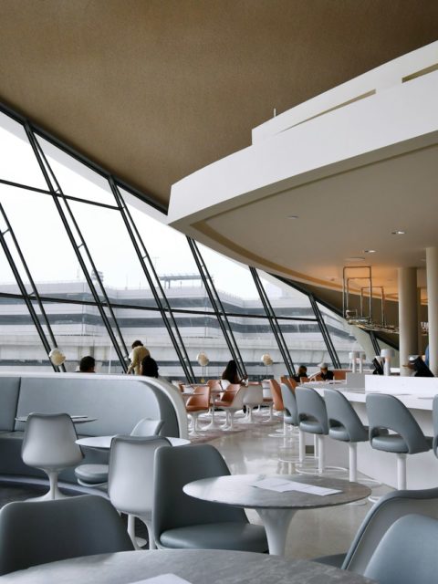 people sitting on white chairs inside building