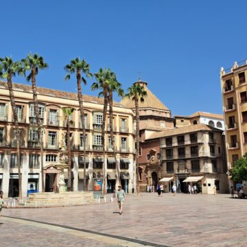 A large building with palm trees in front of it