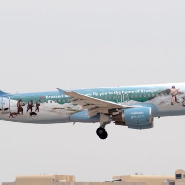 white and blue air plane in mid air during daytime