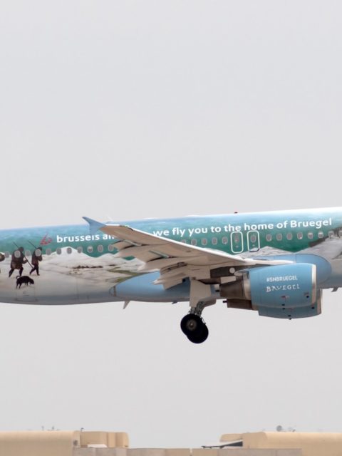 white and blue air plane in mid air during daytime
